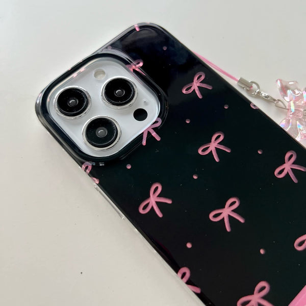 Elegant phone case features a glossy black finish with cute pink bow prints with charm