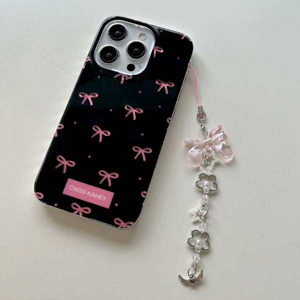 Elegant phone case features a glossy black finish with cute pink bow prints with charm